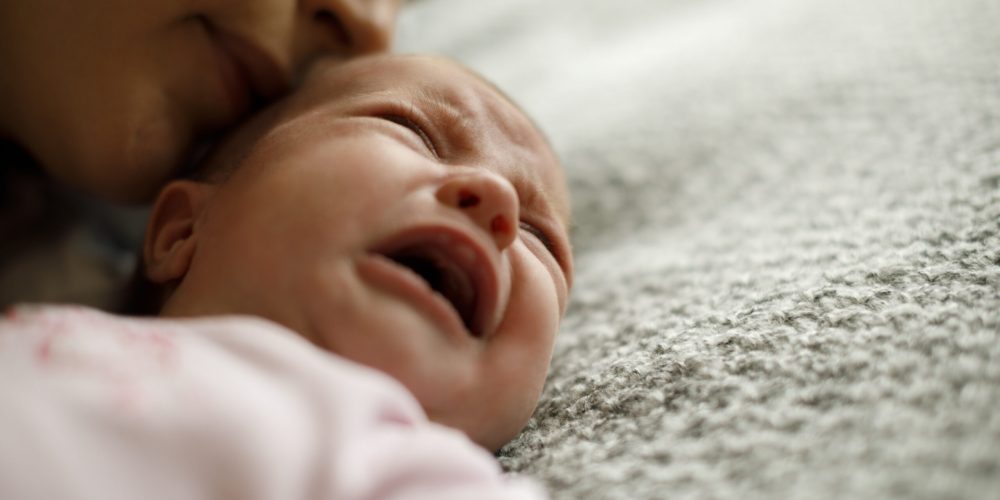 Mother calming her crying baby girl